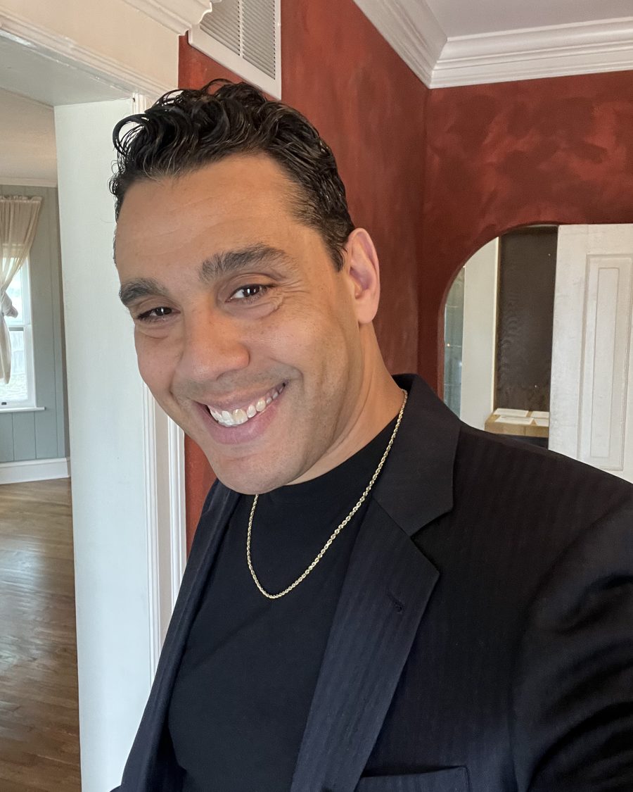 Raul Morales, REALTOR®, smiling in a dark blazer